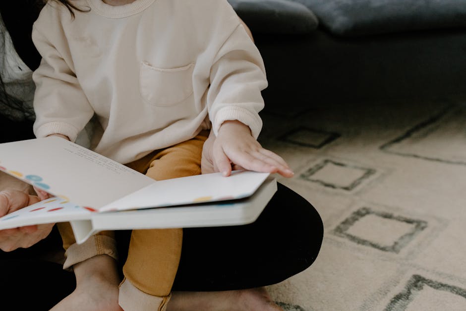 toddler learning to speak with parent reading book