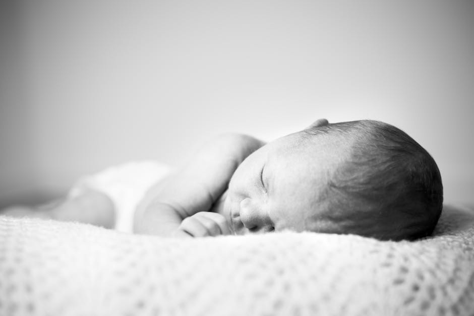 newborn baby sleeping peacefully in crib soft light