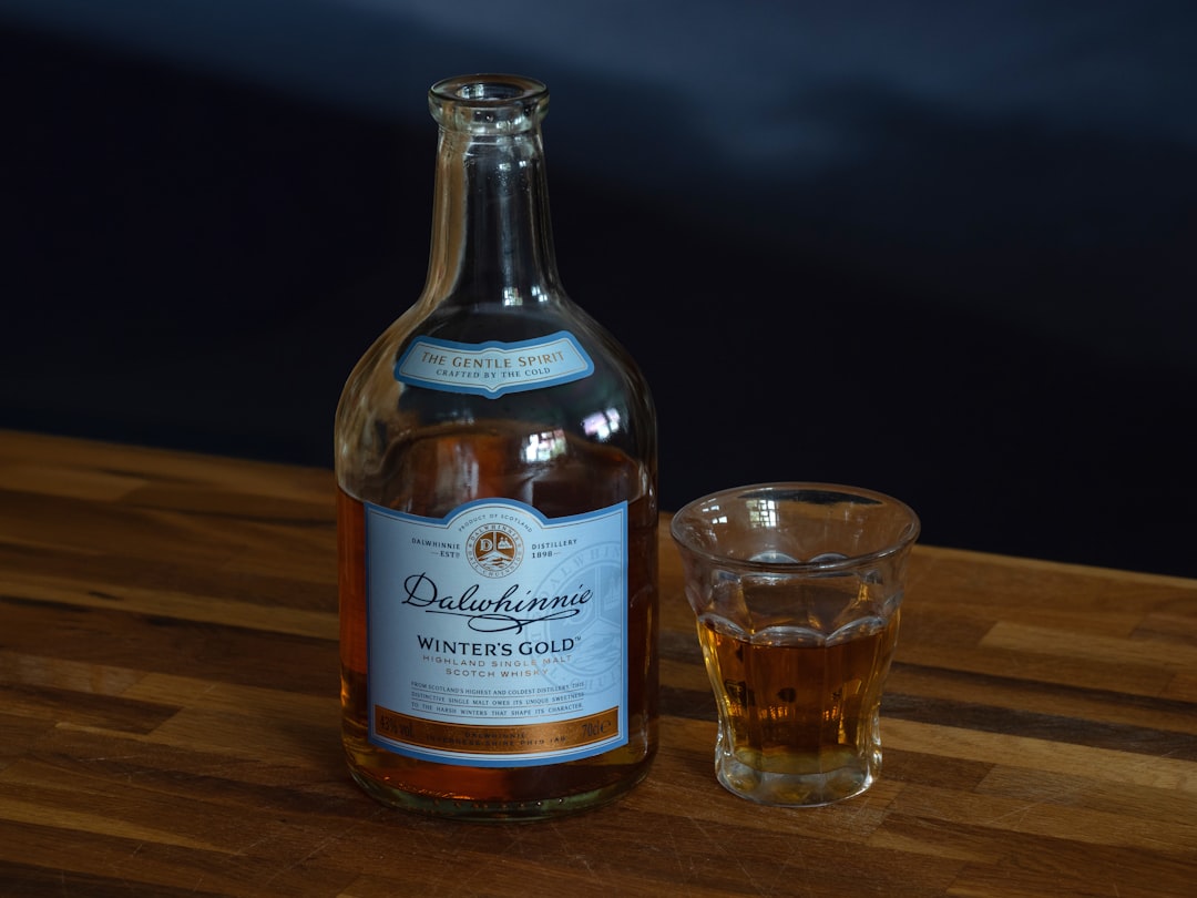 single malt whisky bottles lineup, scottish distillery amber glass