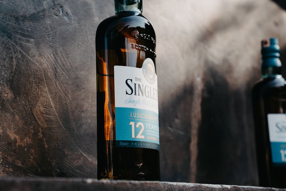 GlenAllachie 12 year old whisky bottle sherry cask, whisky tasting glass amber liquid