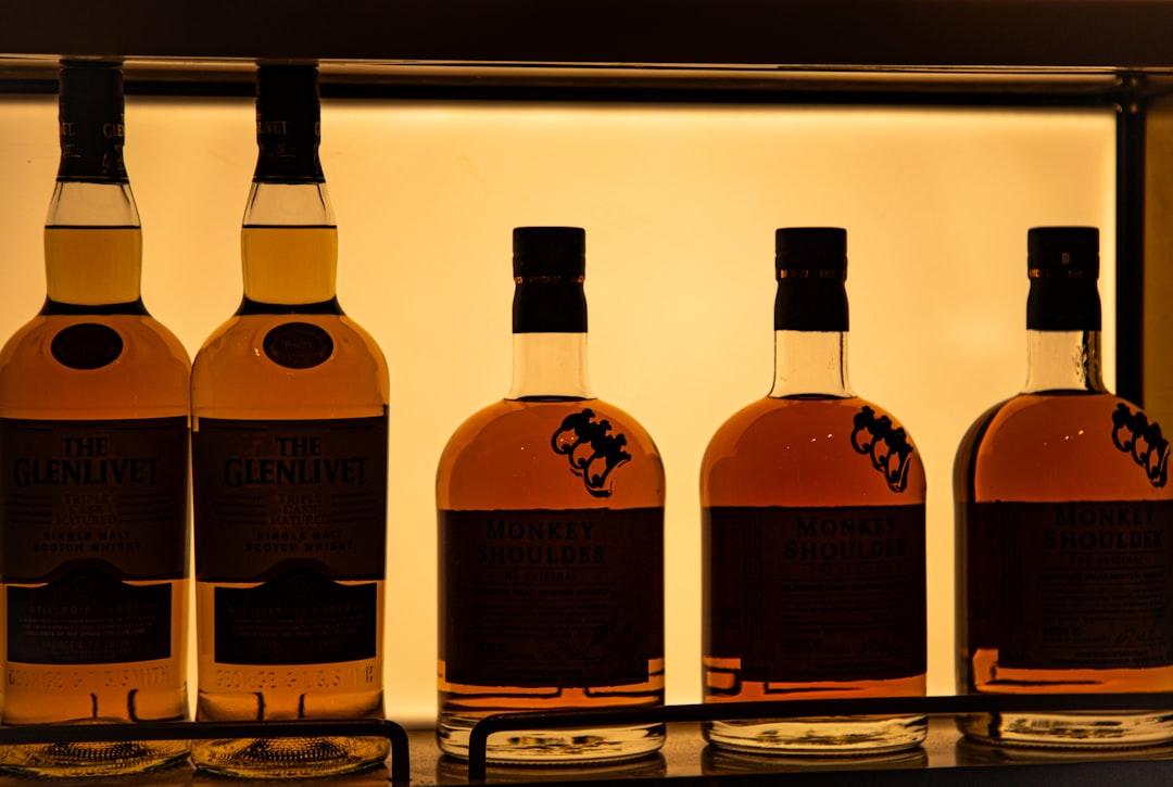 single malt whisky bottles lineup, scotch whisky tasting glass amber